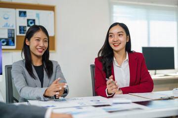 Asian businesswomen discussing business strategy during a corporate meeting in a modern office