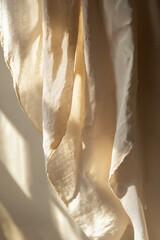 Wall Mural - soft beige fabric drapes in sunlight with gentle shadows for interior decoration and textile inspira