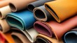 © Sumet - Close-up of rolled leather materials showcasing various colors and textures, perfect for crafting or fashion projects.