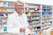 © peopleimages.com - Man, portrait and pharmacist with medical prescription at dispensary for medication, supplements or pills. Chemist, inventory and mature apothecary with packet for medicine or tablets in drug store