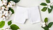 © pvl0707 - Stylish men's boxer shorts nestled among soft cotton flowers in a serene flat lay arrangement, perfect for minimalistic aesthetics