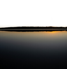 Wall Mural - A very calm early morning lake reflecting a clear blue sky with a transparent sky
