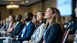 © BURIN93 - Group of attendees listening intently to a speaker at a career seminar, large presentation screen in the background, professional conference, skills training