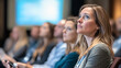 © BURINKUL - Group of attendees listening intently to a speaker at a career seminar, large presentation screen in the background, professional conference, skills training