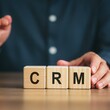 © iamfrk7 - Wooden blocks spelling 'CRM' , symbolizing customer relationship management, business growth, client data, sales, marketing, service, and corporate strategy concepts.