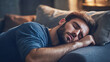 © BURINKUL - Man lying on a couch, looking drained with his eyes halfclosed, endofday fatigue, rest