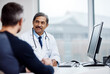 © peopleimages.com - Doctor, computer and consulting with mature man in office for healthcare advice, online chart and life insurance. Diagnosis, medical and exam with people in hospital for treatment and prescription