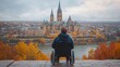 © Emiliia - A tourist in a wheelchair enjoying autumn views of a historic castle across the river