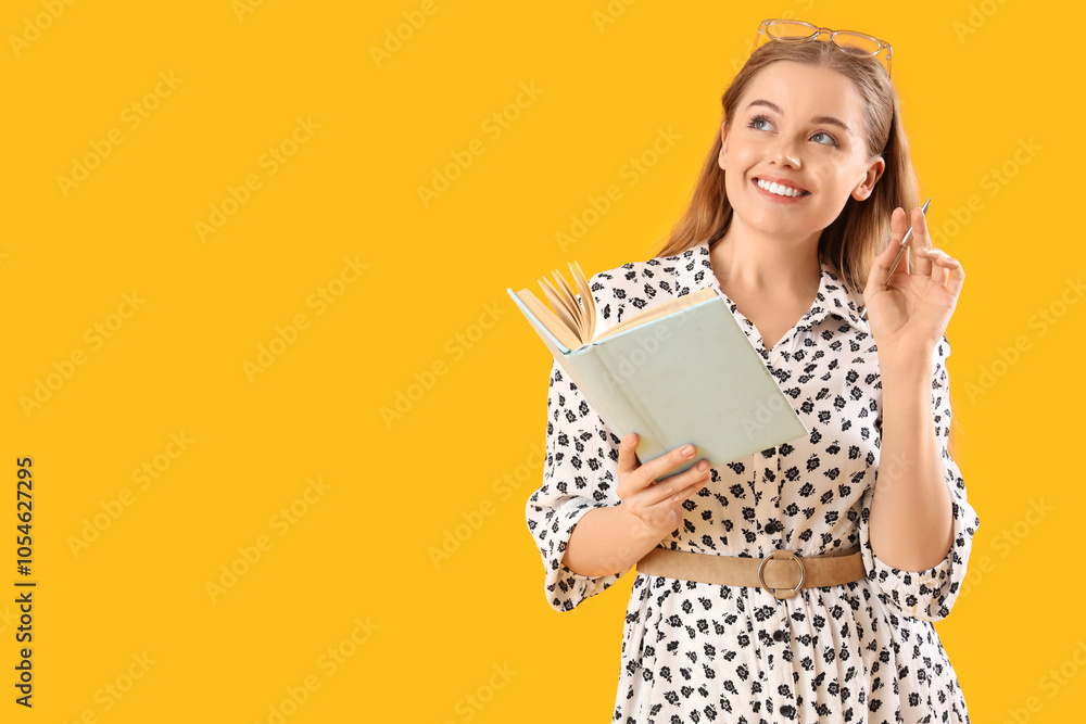 Thoughtful young woman with eyeglasses and notebook on yellow background