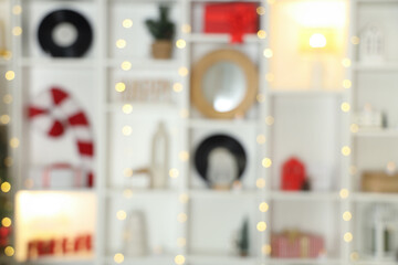 Shelving unit with Christmas decor in living room, blurred view