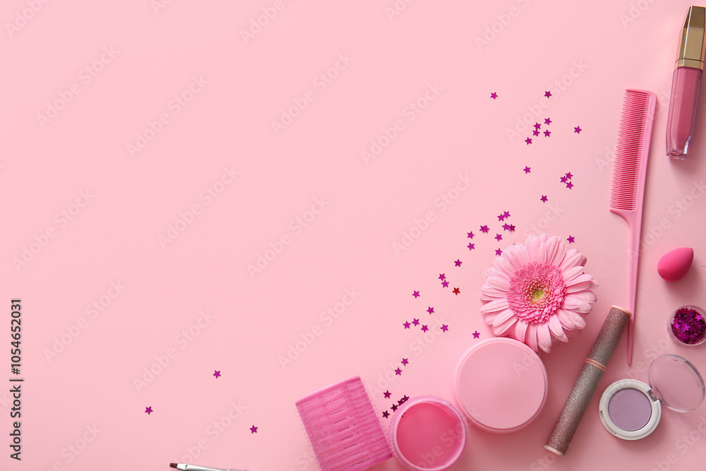 Composition with cosmetic products, accessories and flower on pink background