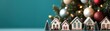 © JAKE STUDIO - A festive scene featuring decorative houses lined up near a Christmas tree with colorful ornaments, creating a warm holiday atmosphere.