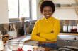 © Wavebreak Media - Smiling african american woman in kitchen preparing thanksgiving meal, at home