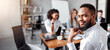 © Prostock-studio - Black Businessman Smiling To Camera Sitting With Coworkers On Corporate Meeting In Modern Office.
