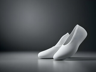 Elegant white ballet shoes on a smooth surface, creating a serene and artistic feel.