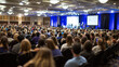 © kaliel - Audience at the conference hall. Speaker giving a talk on corporate Business Conference. Business and Entrepreneurship event.