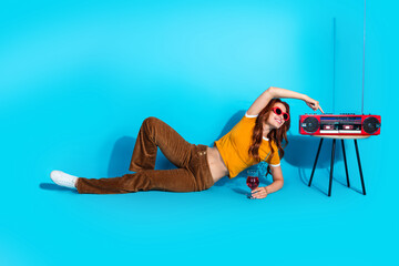 Photo of cheerful positive cute woman wear stylish clothes turn on radio music isolated on blue color background