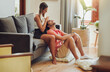 © peopleimages.com - Happy, couple and caressing hair, relax and massaging of head, love and people on date in living room. House, hairdresser and treatment for haircare, smile and romance in lounge, woman and break