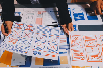 The designer team is designing the uxui system to make the uxui system work well on new phones and support system updates. Website development concept UI UX front end designer