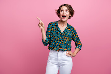 Photo of impressed girl with bob hair dressed print shirt directing look at amazing offer empty space isolated on pink color background