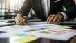 © diracreativa - Businessman Analyzing Financial Charts and Graphs with Sticky Notes