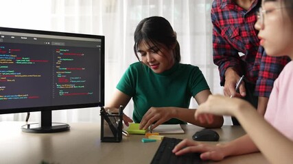 Slow motion back end software developer engineer for computer programming working together on debugging writing computing code, solving complex algorithms display on monitor in office. Burgeoning