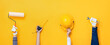 © Atstock Productions - Hands holding construction tools and equipment in yellow banner background