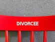 © ariya j - Red chair back with text inscription DIVORCEE - man or woman who formal ending of marriage by law - a person whose marriage has been legally ended