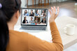 © NAMPIX - A woman sits at a desk with a laptop open, displaying a video conference meeting with her partnership.
