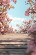 © grey - The wooden floor is surrounded by pink flowers, creating an outdoor scene with a blurred background.