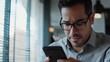 © WS Studio 1985 - Focused Person Using Smartphone in Modern Cafe Setting