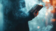 © ZEUS - A person stands shrouded in smoke, holding a closed book, their face obscured. The book is a symbol of knowledge and wisdom, while the smoke represents mystery, uncertainty, and the unknown.