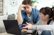 © auremar - frustrated couple looking at a laptop