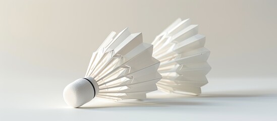 A white background with two white shuttlecocks for badminton creates a simple and elegant copy space image