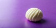 © Latsamee - White round chocolate on purple background
