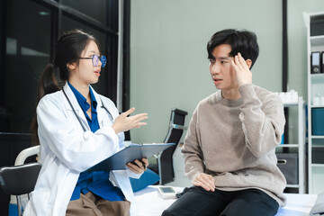 medicine, healthcare and people concept - doctor talking to male patient at bed in hospital.