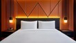 Close-up of a modern hotel bed with crisp white linens, decorative pillows, and an accent wall behind the headboard, Stylish hotel bed setup, Comfortable and refined