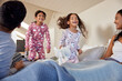 © Rido - Happy smiling girls jumping on parents' bed