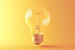 © rokeya - Light Bulb on Yellow Background