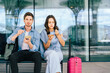 © Iryna - Couple traveler relaxing and healthy lifestyle choice. Young travelers enjoying a meal at urban transportation hub.
