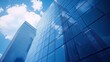 © Ilja - Skyscrapers Reflecting Blue Sky and Clouds. Modern Architecture and Business Success Concept.