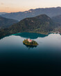 © AmazingAerialAgency - Aerial view of Cerkev Marijinega, a Catholic Church on a small island in the middle of Bled Lake at sunrise, Upper Carniola, Julian Alps, Slovenia.