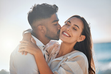 Interracial, kiss or couple hug at ocean for love on vacation, valentines day or holiday in Spain. Happy, relationship and people at sea for bonding together for romantic trip at beach with smile