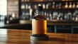 © Sasa Visual - An amber whiskey bottle is prominently placed on a wooden bar top, highlighting its classic style