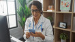 © Krakenimages.com - Hispanic woman doctor smiling while using smartphone in clinic office