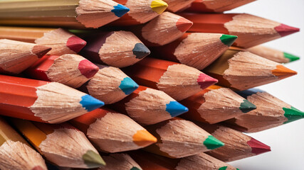 A stack of sharpened colored pencils arranged in an artistic manner, emphasizing the variety of colors and textures.