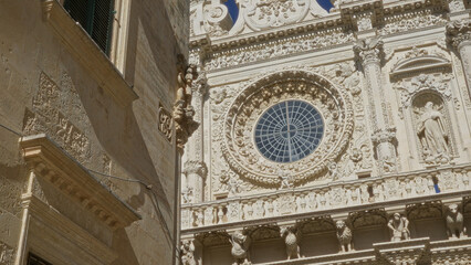 Detailed, intricate, baroque architecture of basilica di santa croce in lecce, puglia, italy, showcasing ornate stone carvings and historic craftsmanship in a sunny european town.