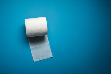 white roll of toilet paper on a blue background.