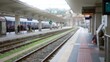 © Krakenimages.com - Blurred passengers stand at a railway station with defocused trains in the background, capturing a sense of motion and travel in the bustling urban setting.