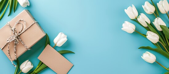 Wall Mural - Gift box white tulips and blank card on a turquoise backdrop with copy space image